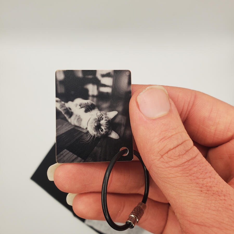 Untitled Laser-engraved pet memorial key chain of a cat on anodized aluminum with a keyloop attached to it.